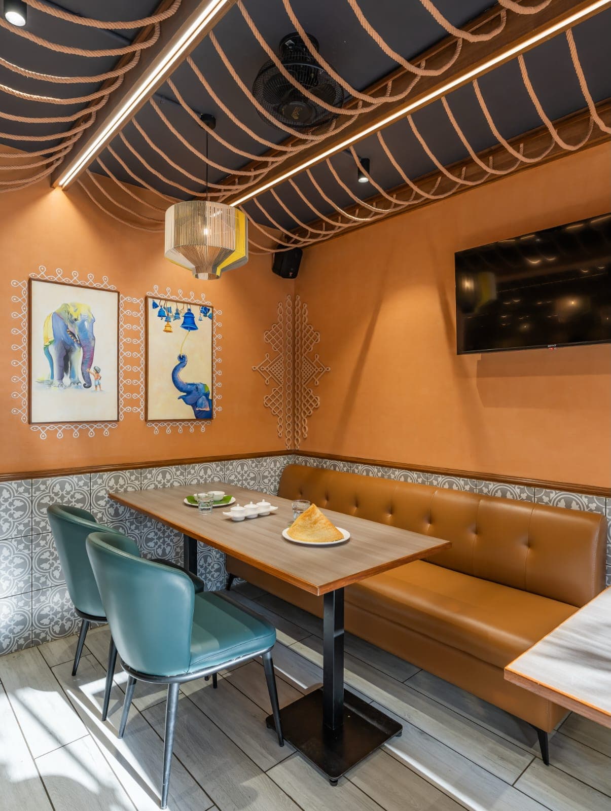 Folk-art dining nook with patterned tile wainscoting